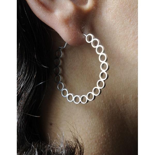 close up of circle hoop earrings on woman