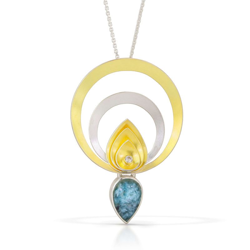 silver and gold circle pendant with Blue Brazilian Gilelite tear drop 