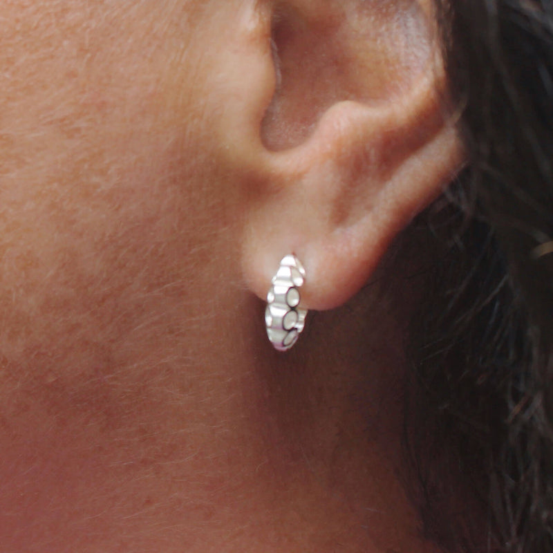 closeup of silver link earrings on woman 