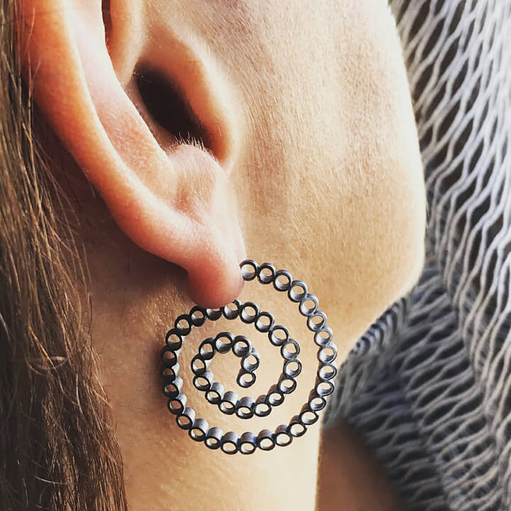 close up of silver hoops on woman