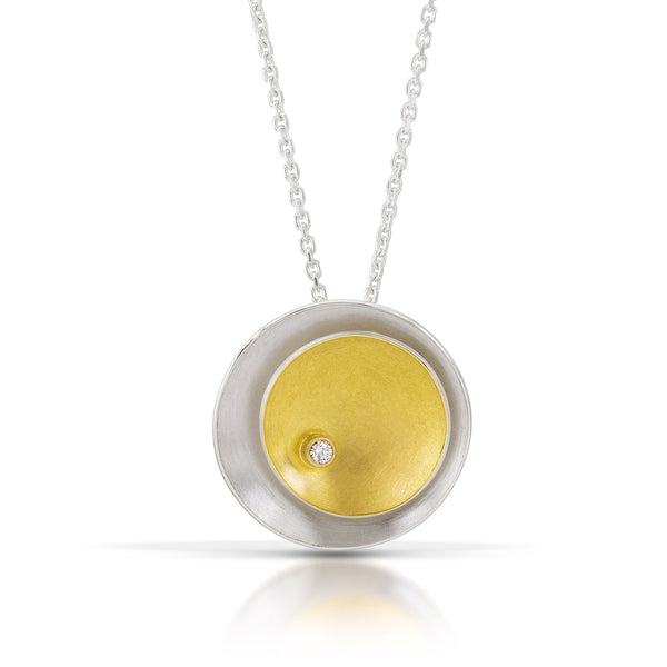 gold and silver circle pendant with diamond